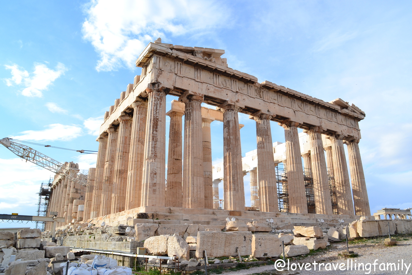 The columns of the Parthenon on the Acropolis in Athens under a pale blue sky.