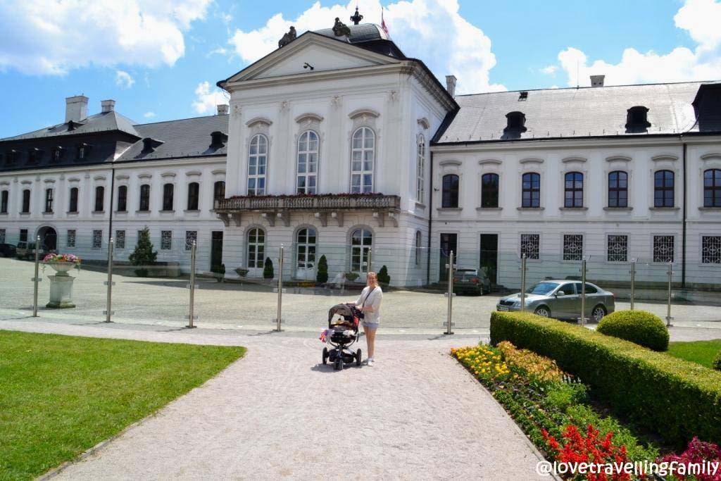 A family stop with a stroller outside Bratislava’s Presidential Palace.